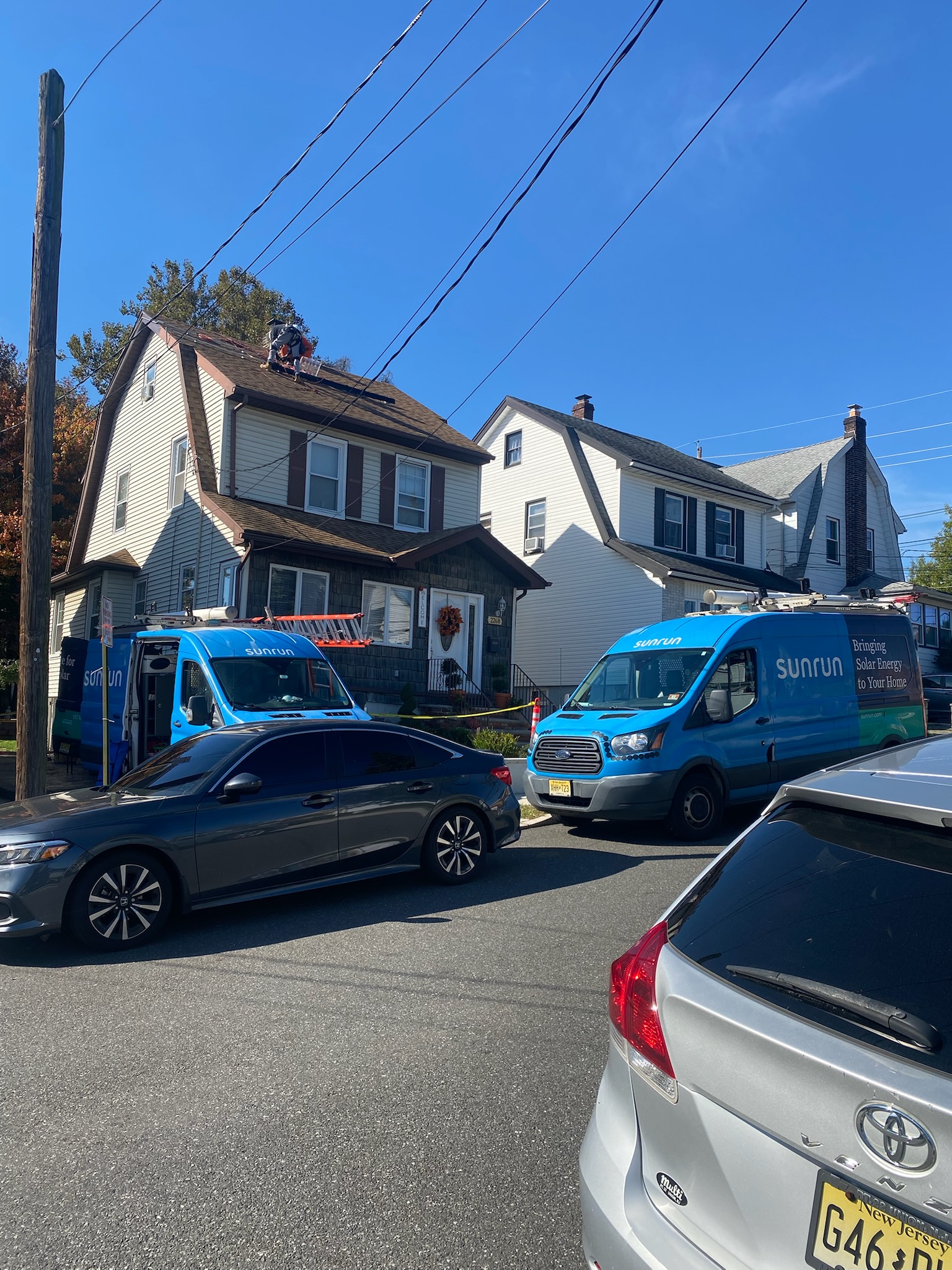 Real Sunrun installation in New Jersey, crew vans on site